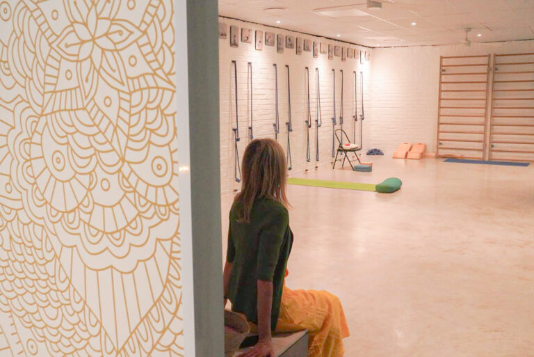 woman in sitting inside yoga studio